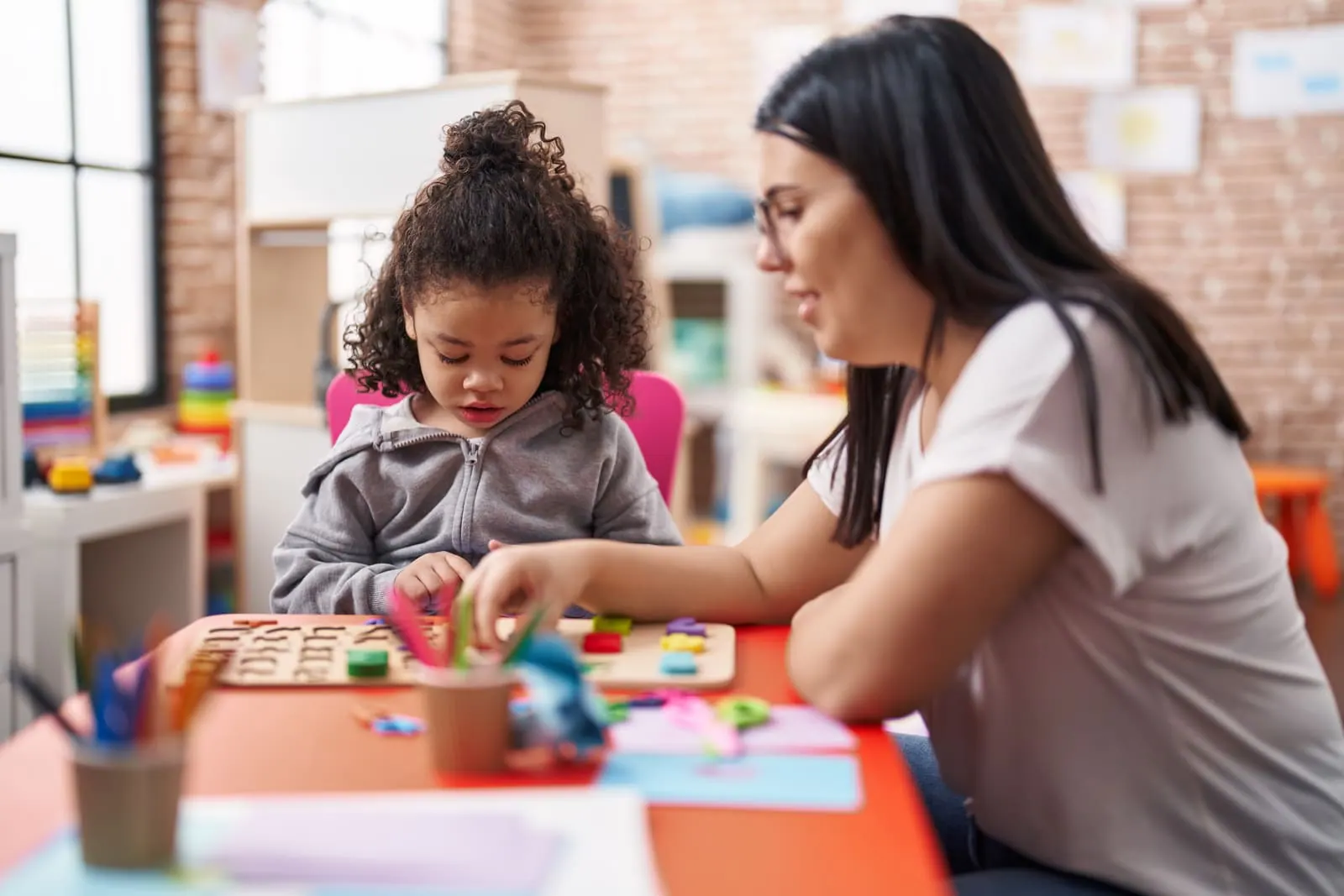 A special education teacher working one-on-one with a young student